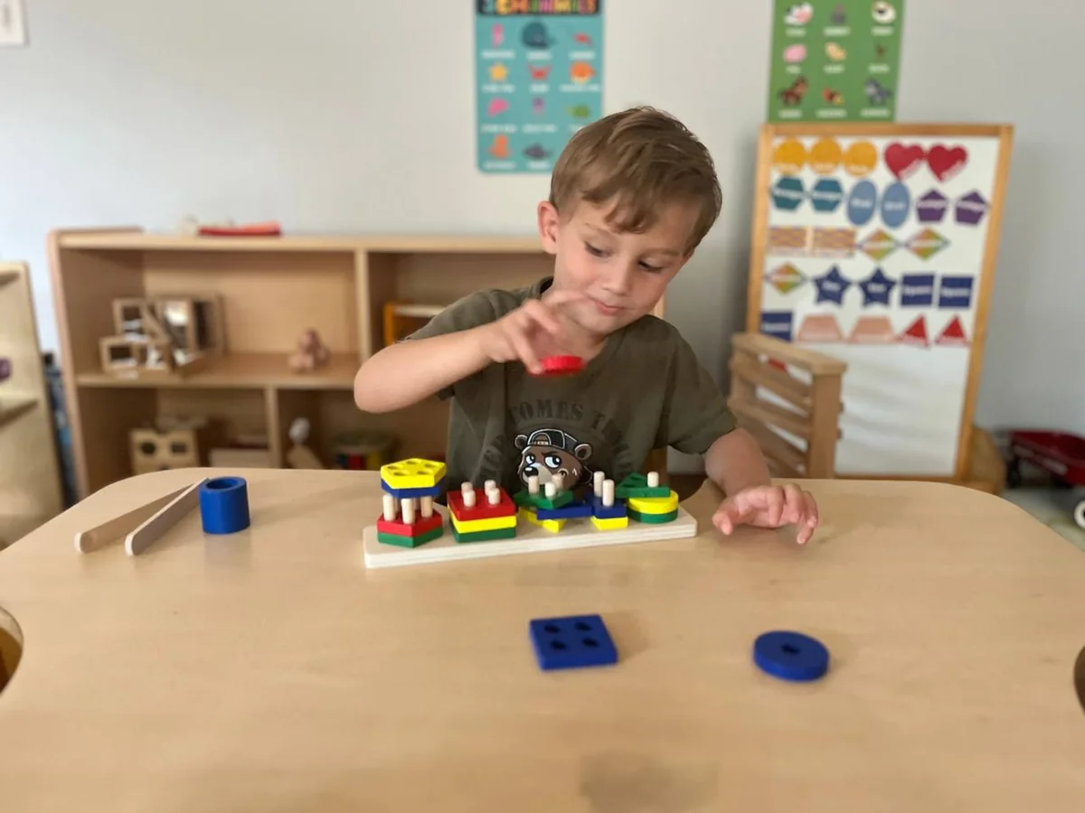 Child engaged in purposeful color and shape activity at Bethany Happy Hearts